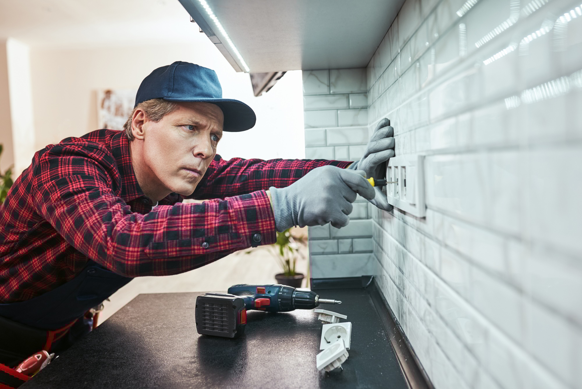 Sockets installation. Close-up of senior handyman setting new sockets